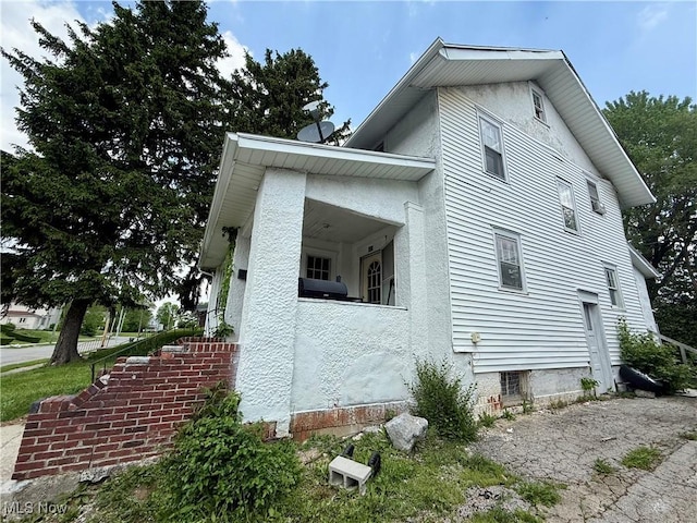 327 Garfield Ave, Lima, OH 45805 - view of side of home featuring stucco siding