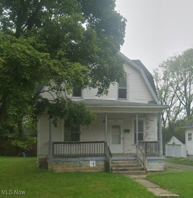 319 S Nye St, Lima, OH 45801 - view of front of property with a gambrel roof, a porch, and a front lawn