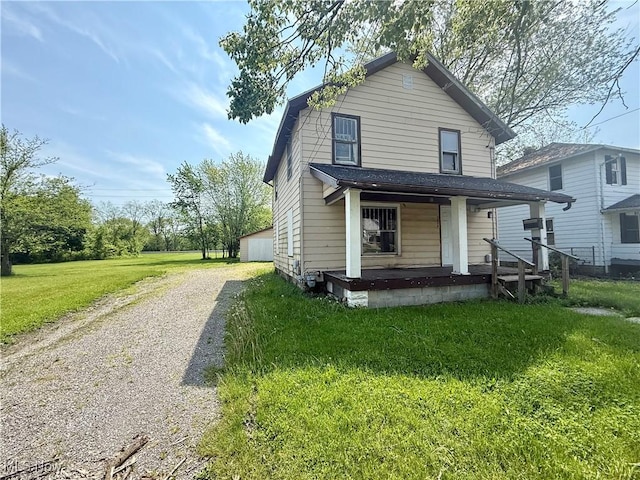 1026 N Central Ave, Lima, OH 45801 - view of front of house featuring covered porch, driveway, and a front lawn