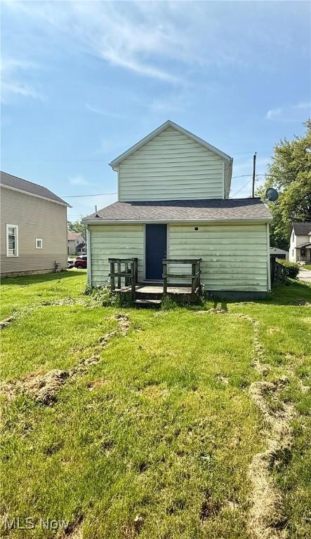 406 Ewing Ave, Lima, OH 45801 - rear view of house featuring a yard and a wooden deck