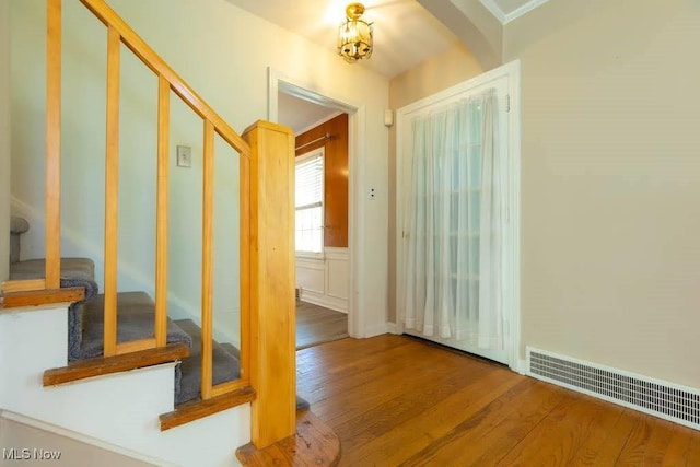 4020 Colony Rd, South Euclid, OH 44121 - corridor featuring stairs, wood finished floors, and arched walkways