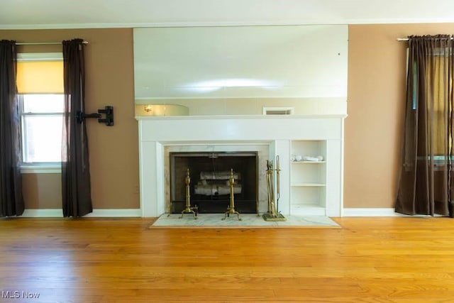 4020 Colony Rd, South Euclid, OH 44121 - detailed view of baseboards, wood finished floors, a fireplace with flush hearth, and built in features
