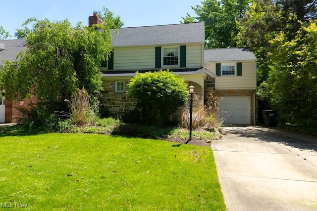 4020 Colony Rd, South Euclid, OH 44121 - view of front of home featuring concrete driveway, an attached garage, a chimney, a front yard, and stone siding