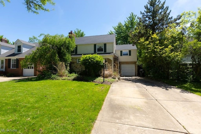 4020 Colony Rd, South Euclid, OH 44121 - view of front of house featuring concrete driveway, a front yard, a garage, and brick siding