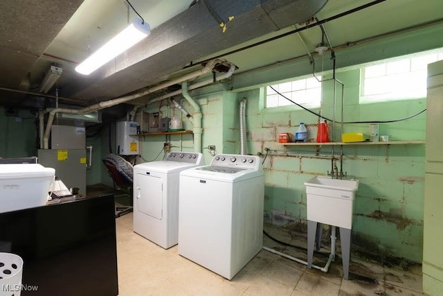 4020 Colony Rd, South Euclid, OH 44121 - laundry area with washing machine and dryer, tankless water heater, and heating unit