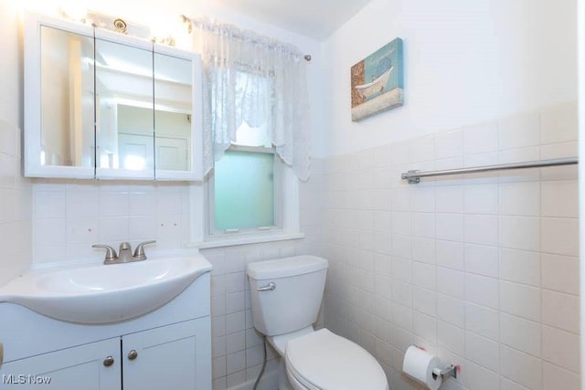 4020 Colony Rd, South Euclid, OH 44121 - bathroom featuring tile walls, toilet, and vanity