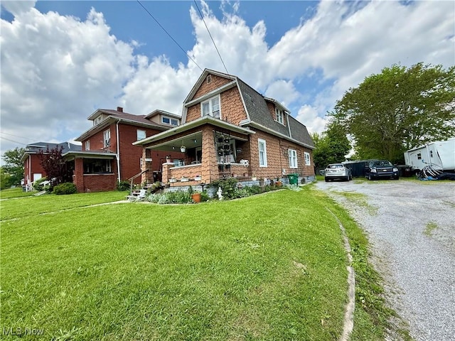 924 W Elm St, Lima, OH 45801 - view of property exterior with a yard, roof with shingles, and a porch