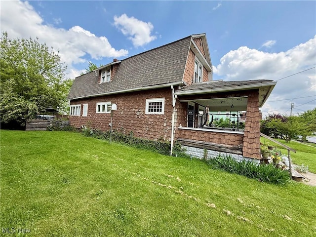 924 W Elm St, Lima, OH 45801 - view of side of property with a shingled roof, a yard, and a gambrel roof