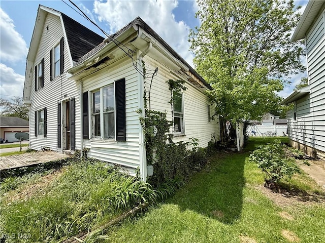 503 N Charles St, Lima, OH 45805 - view of property exterior with a lawn, a gambrel roof, and roof with shingles