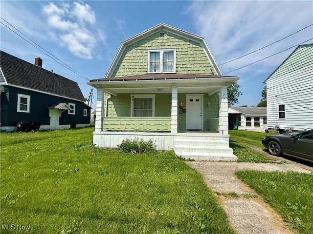 731 N Baxter St, Lima, OH 45801 - colonial inspired home with a porch, a gambrel roof, and a front lawn