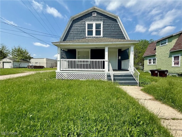 727 N Baxter St, Lima, OH 45801 - dutch colonial with a porch, a gambrel roof, a front yard, and a shingled roof
