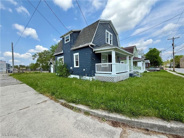 727 N Baxter St, Lima, OH 45801 - view of side of home featuring covered porch, a gambrel roof, a shingled roof, and a lawn