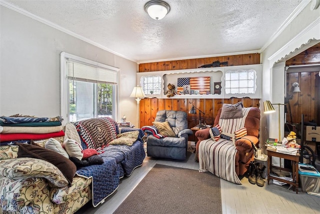 4202 Walter Ave, Parma, OH 44134 - living area with a textured ceiling, wood finished floors, plenty of natural light, and ornamental molding