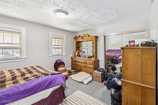 4202 Walter Ave, Parma, OH 44134 - bedroom featuring multiple windows, a closet, and a textured ceiling