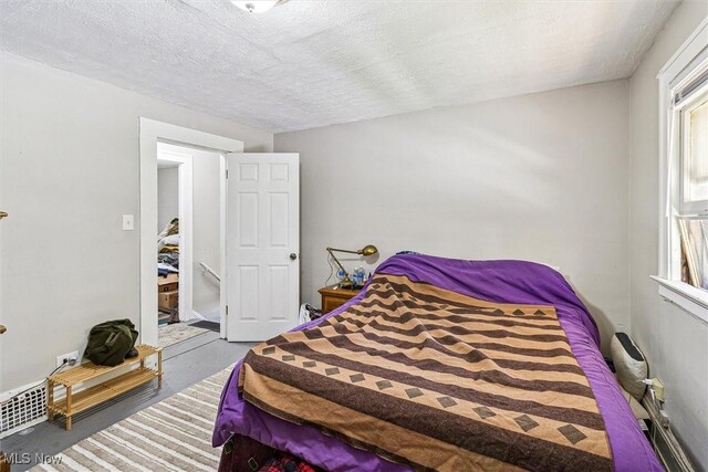 4202 Walter Ave, Parma, OH 44134 - bedroom with a textured ceiling and finished concrete floors