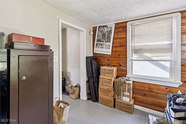 4202 Walter Ave, Parma, OH 44134 - interior space featuring a textured ceiling, wood walls, and wood finished floors