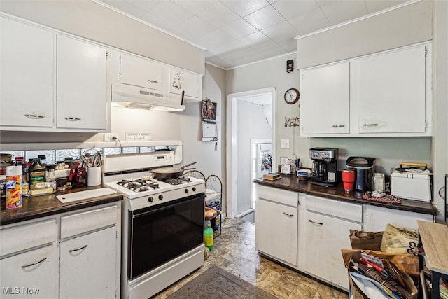 4202 Walter Ave, Parma, OH 44134 - kitchen with gas range gas stove, under cabinet range hood, ornamental molding, white cabinetry, and dark countertops