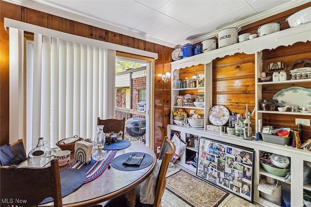 4202 Walter Ave, Parma, OH 44134 - dining area featuring wooden walls and ornamental molding
