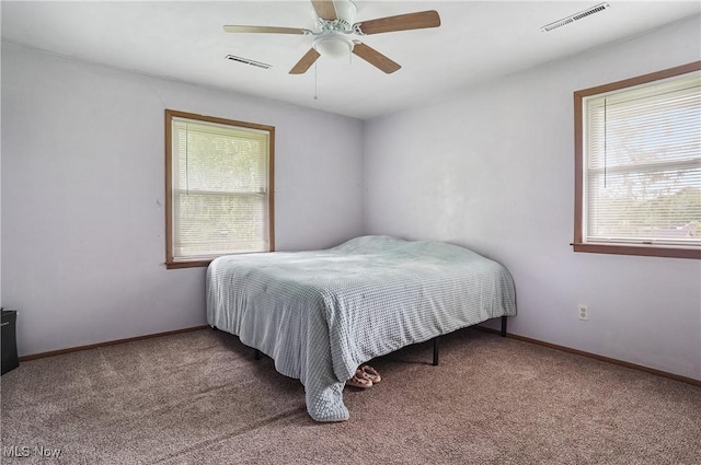 7182 Stewart Sharon Rd, Hubbard, OH 44425 - carpeted bedroom with multiple windows, baseboards, and a ceiling fan