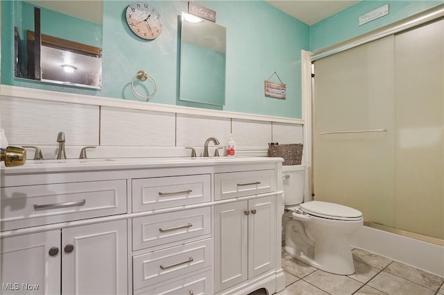 7182 Stewart Sharon Rd, Hubbard, OH 44425 - bathroom with tile patterned floors, toilet, a shower stall, and double vanity