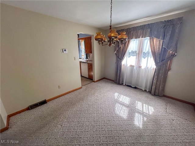 100 Chadwick Ln, Austintown, OH 44515 - unfurnished room featuring a chandelier, light carpet, and plenty of natural light