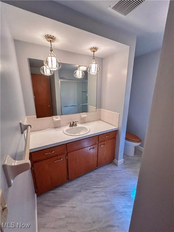 100 Chadwick Ln, Austintown, OH 44515 - bathroom featuring vanity, backsplash, and toilet