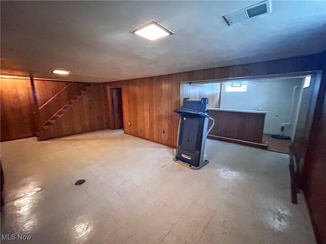 100 Chadwick Ln, Austintown, OH 44515 - basement with wooden walls, stairs, light flooring, and a dry bar