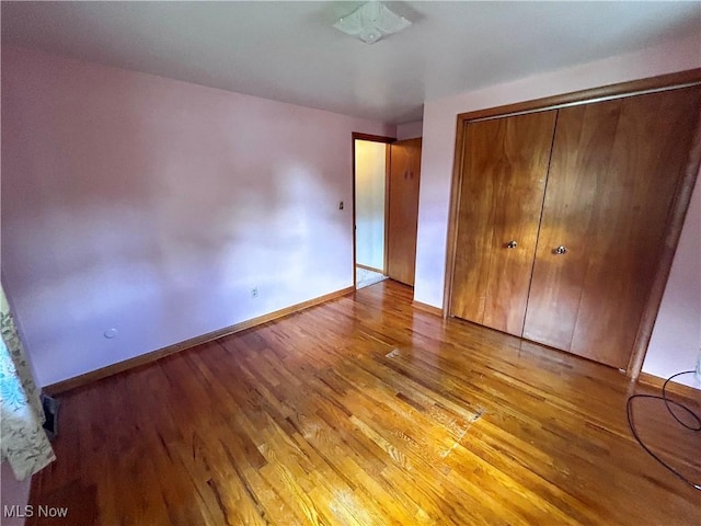 100 Chadwick Ln, Austintown, OH 44515 - unfurnished bedroom featuring wood finished floors, a closet, and baseboards