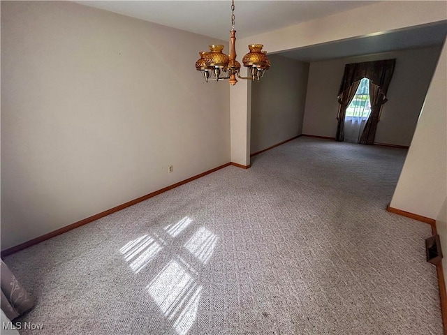 100 Chadwick Ln, Austintown, OH 44515 - empty room featuring carpet flooring, a chandelier, and baseboards