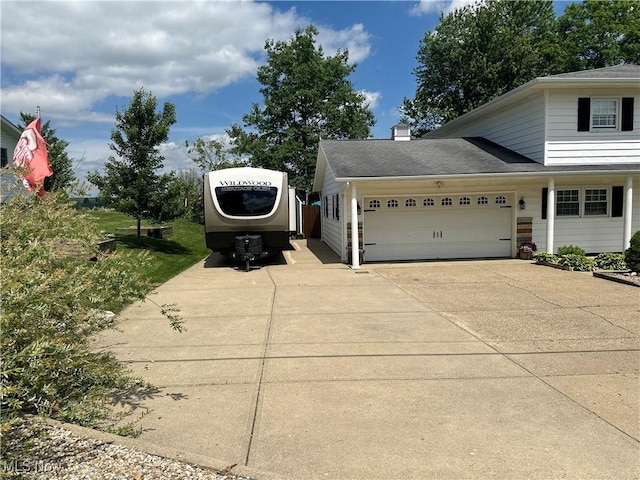 59010 Palmer St, Byesville, OH 43723 - view of home's exterior with an attached garage, driveway, and a chimney