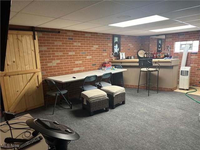 59010 Palmer St, Byesville, OH 43723 - interior space featuring carpet, brick wall, a paneled ceiling, and baseboards