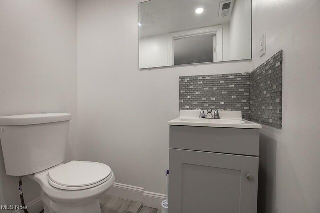 2205 W 85th St, Cleveland, OH 44102 - bathroom featuring baseboards, tasteful backsplash, vanity, and toilet