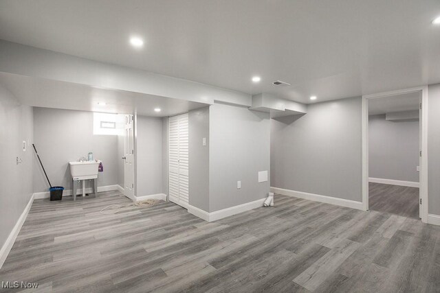 2205 W 85th St, Cleveland, OH 44102 - finished basement with wood finished floors, recessed lighting, baseboards, and a sink