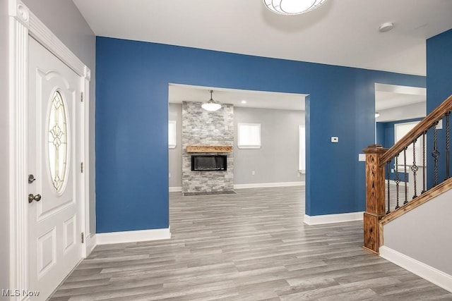 2205 W 85th St, Cleveland, OH 44102 - foyer entrance with wood finished floors, stairway, baseboards, and a stone fireplace