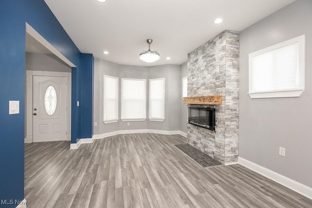 2205 W 85th St, Cleveland, OH 44102 - unfurnished living room with wood finished floors, baseboards, a fireplace, and recessed lighting