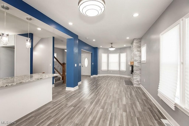 2205 W 85th St, Cleveland, OH 44102 - unfurnished living room with light wood-type flooring, stairway, baseboards, and recessed lighting