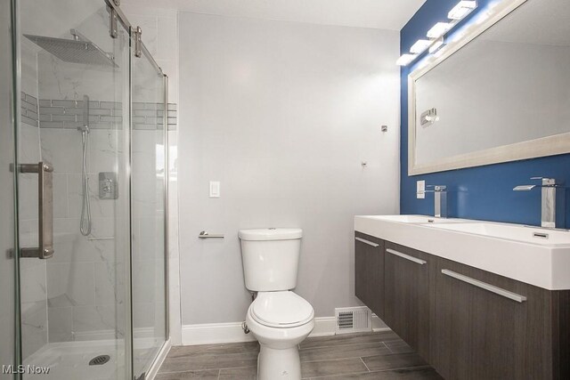 2205 W 85th St, Cleveland, OH 44102 - bathroom featuring a shower stall, baseboards, toilet, and vanity