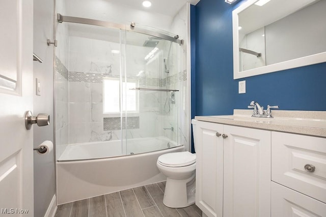 2205 W 85th St, Cleveland, OH 44102 - bathroom with toilet, wood finished floors, vanity, and combined bath / shower with glass door