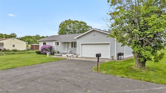 single story home featuring a garage, driveway, and a front yard