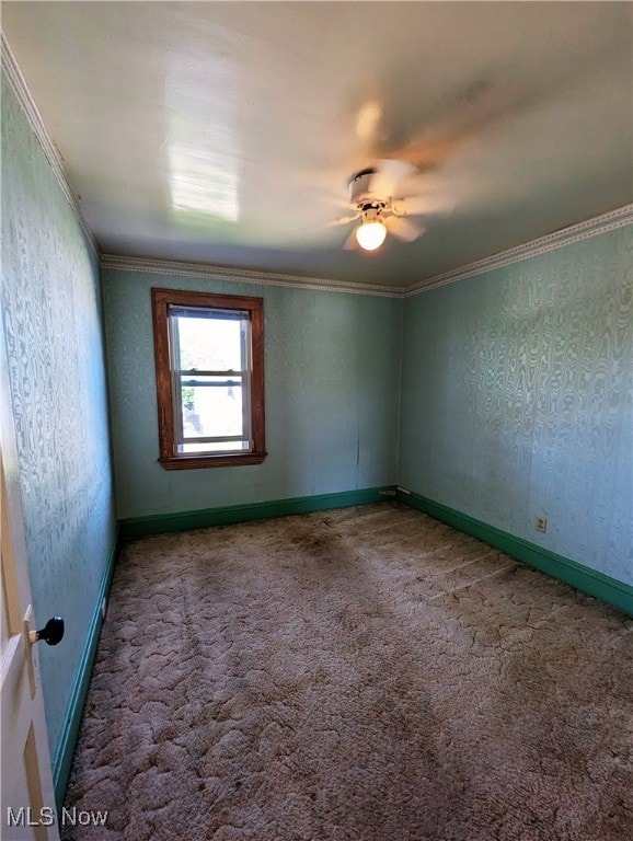 carpeted empty room featuring ornamental molding and baseboards