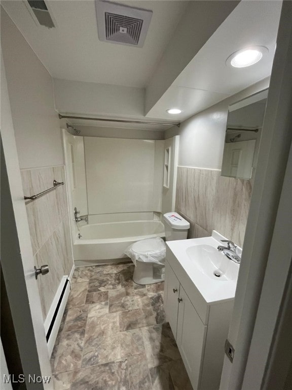 5135 Berkshire Dr, North Olmsted, OH 44070 - bathroom with a baseboard heating unit, tile walls, wainscoting, shower / tub combination, and toilet