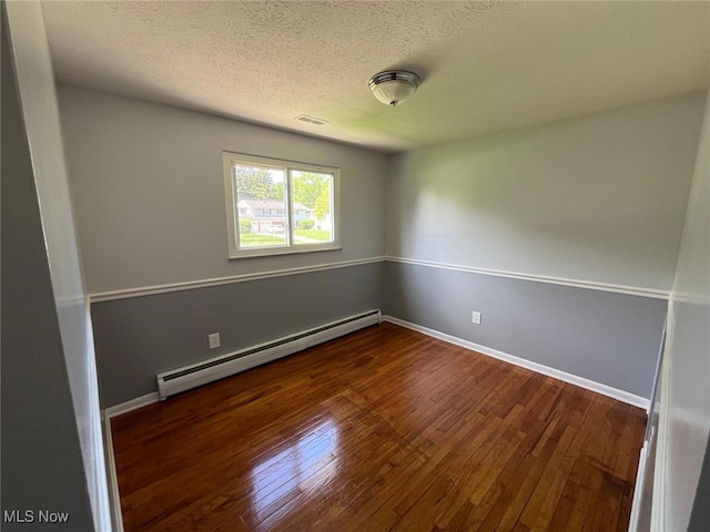 5135 Berkshire Dr, North Olmsted, OH 44070 - empty room with a baseboard heating unit, wood finished floors, a textured ceiling, and baseboards