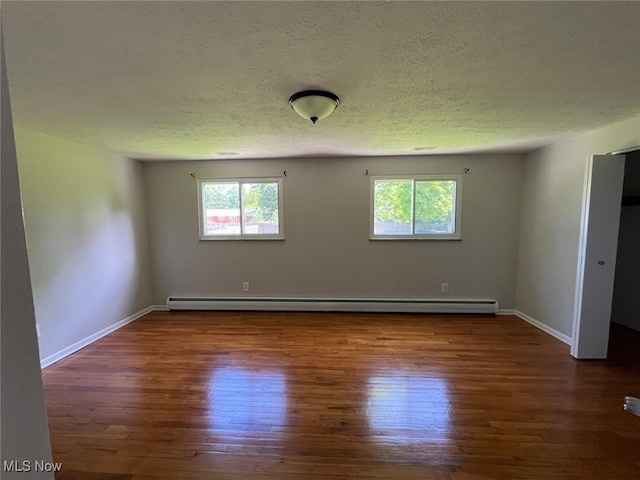 5135 Berkshire Dr, North Olmsted, OH 44070 - unfurnished room featuring healthy amount of natural light, wood finished floors, baseboards, and a textured ceiling