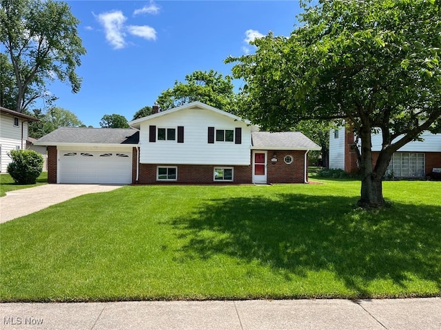 5135 Berkshire Dr, North Olmsted, OH 44070 - split level home featuring an attached garage, concrete driveway, a front yard, and brick siding