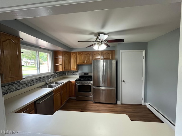 5135 Berkshire Dr, North Olmsted, OH 44070 - kitchen featuring appliances with stainless steel finishes, a sink, a baseboard radiator, tasteful backsplash, and ceiling fan