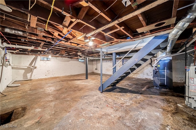 579 Main St, Conneaut, OH 44030 - unfinished below grade area featuring water heater and stairway