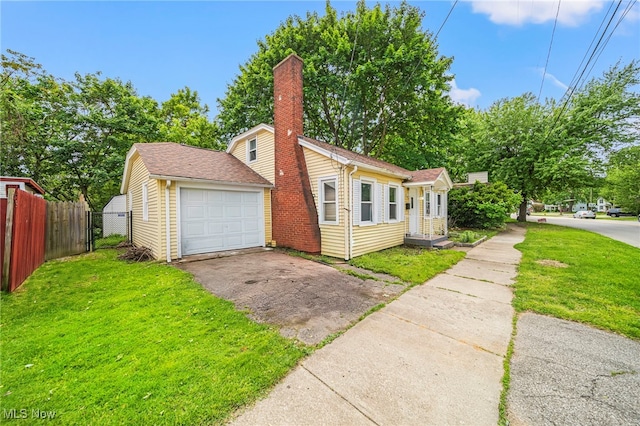 579 Main St, Conneaut, OH 44030 - view of front of house with driveway, a chimney, and a garage