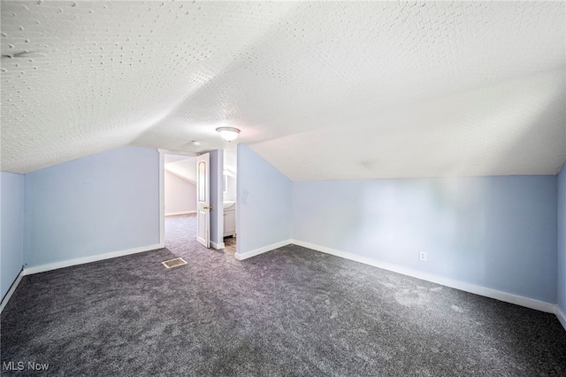 579 Main St, Conneaut, OH 44030 - bonus room featuring carpet, vaulted ceiling, baseboards, and a textured ceiling