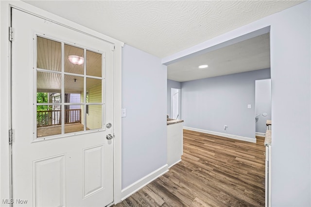 579 Main St, Conneaut, OH 44030 - doorway to outside featuring baseboards, wood finished floors, and recessed lighting