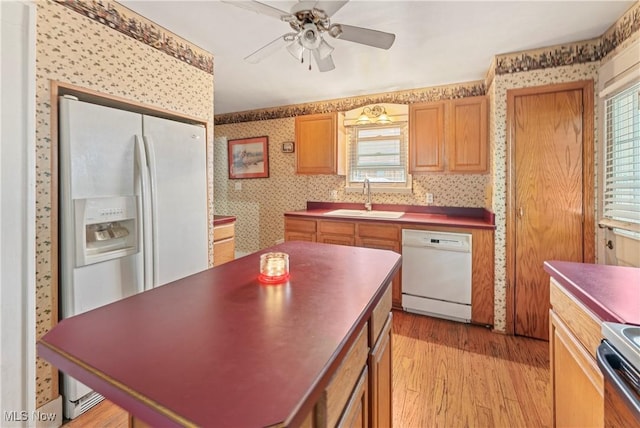 4723 Walnut St, Mantua, OH 44255 - kitchen with a sink, white appliances, wallpapered walls, light wood-style floors, and a ceiling fan